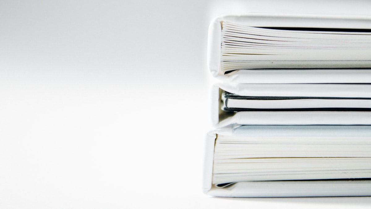 Stack of thick document folders — the file types where metadata removal is most critical before sending