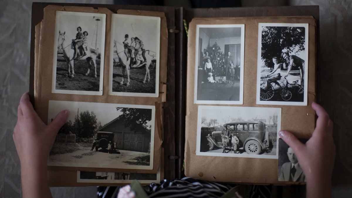 Person opening a photo album — preserving family memories with private sharing that skips facial recognition and cloud analysis