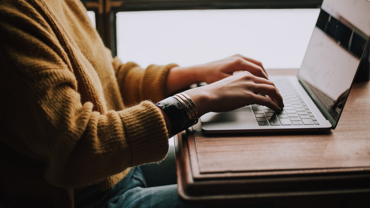 Student using laptop for secure academic file sharing — group projects, submissions, and research data handled correctly